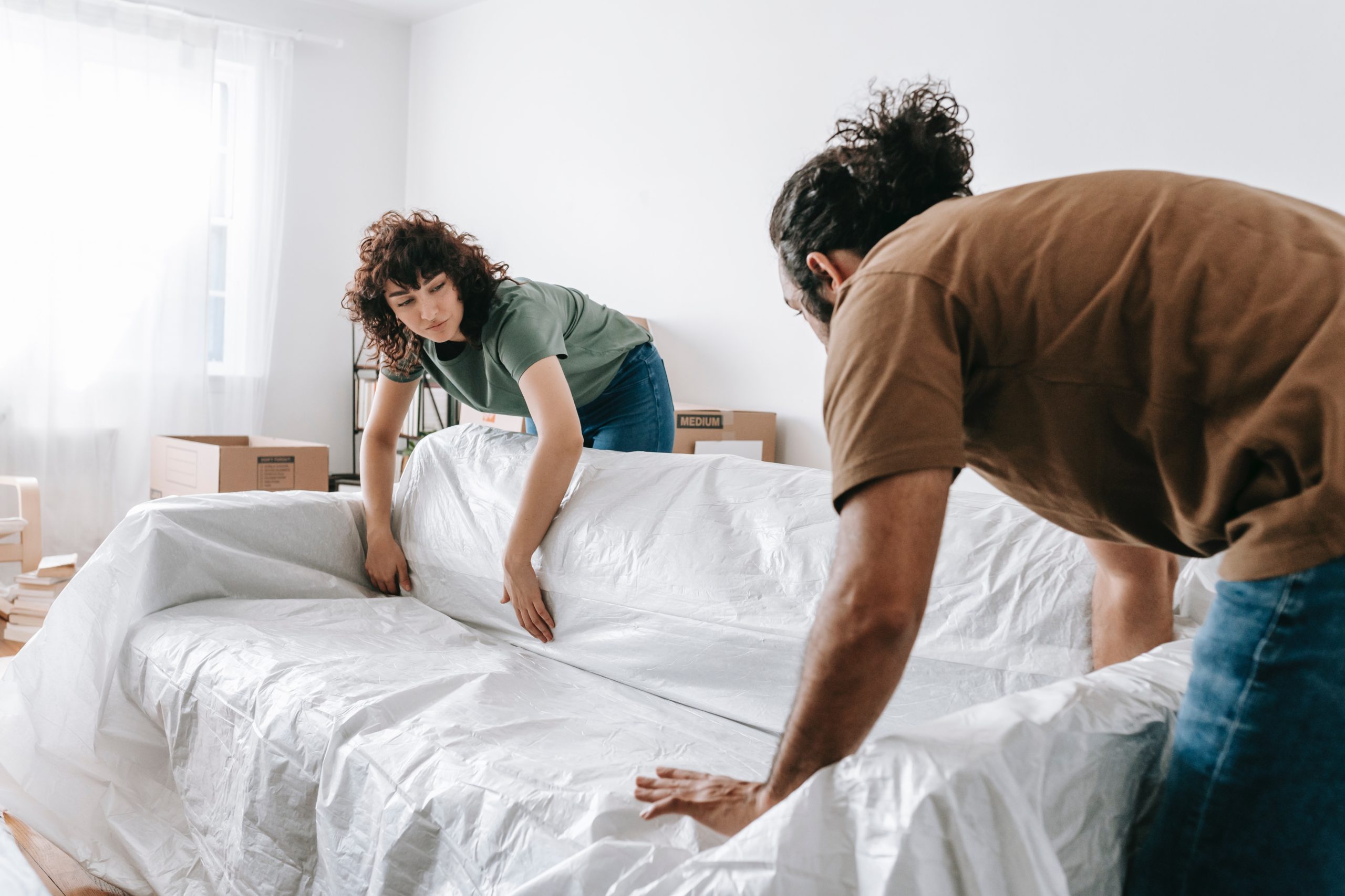 people moving couch out of home