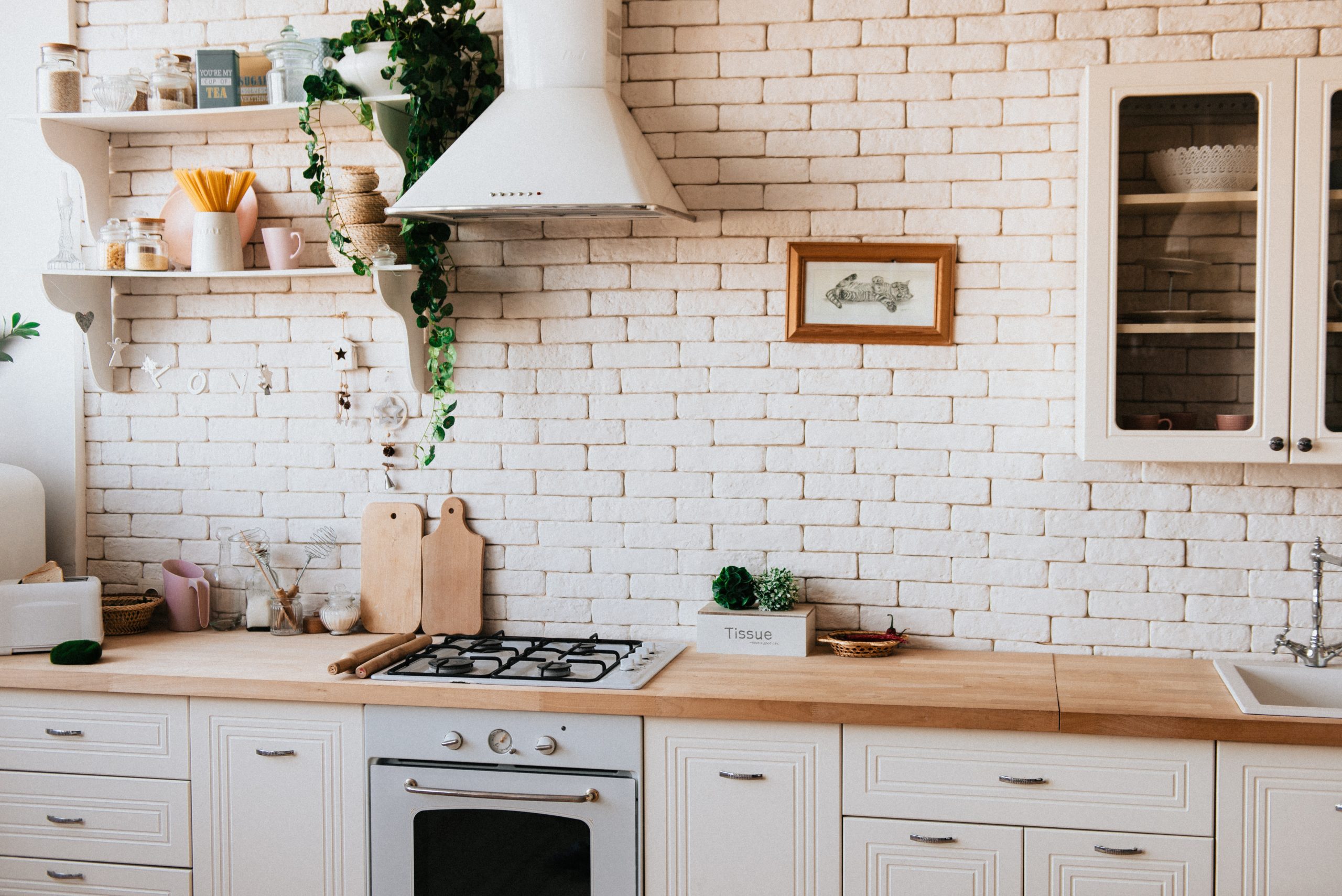 pexels-dmitry-zvolskiy-2062426 farmhouse kitchen with cutting boards under oven hood tulsa home for rent