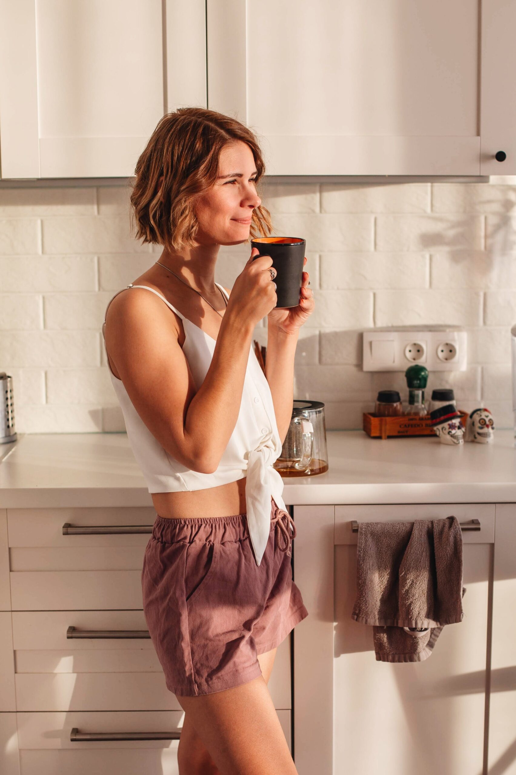 woman standing in kitchen with coffee mug legacy living blog kitchen space