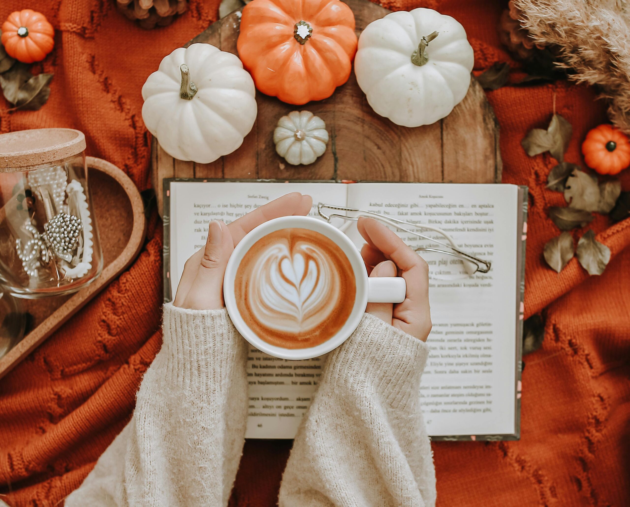 pexels-mlkbnl-7470497 woman holding coffee mug surrounded by fall decor fall cleaning tips blog legacy living