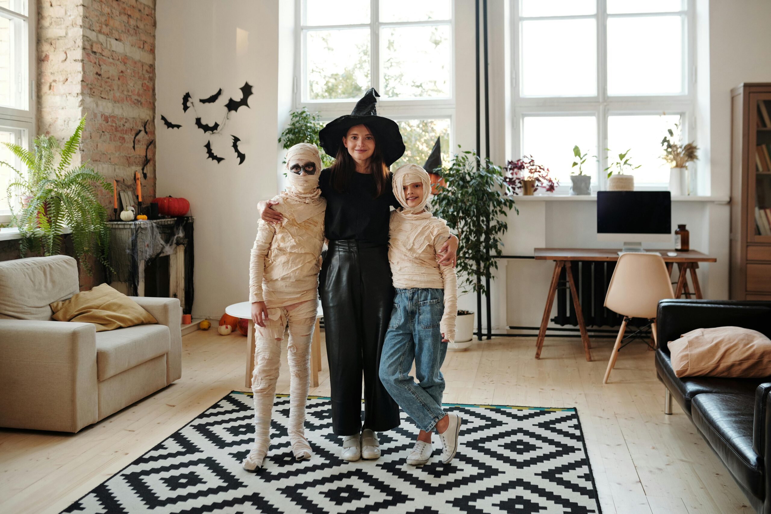 group smiling in different halloween costumes in living room legacy living blog last minute halloween costume ideas