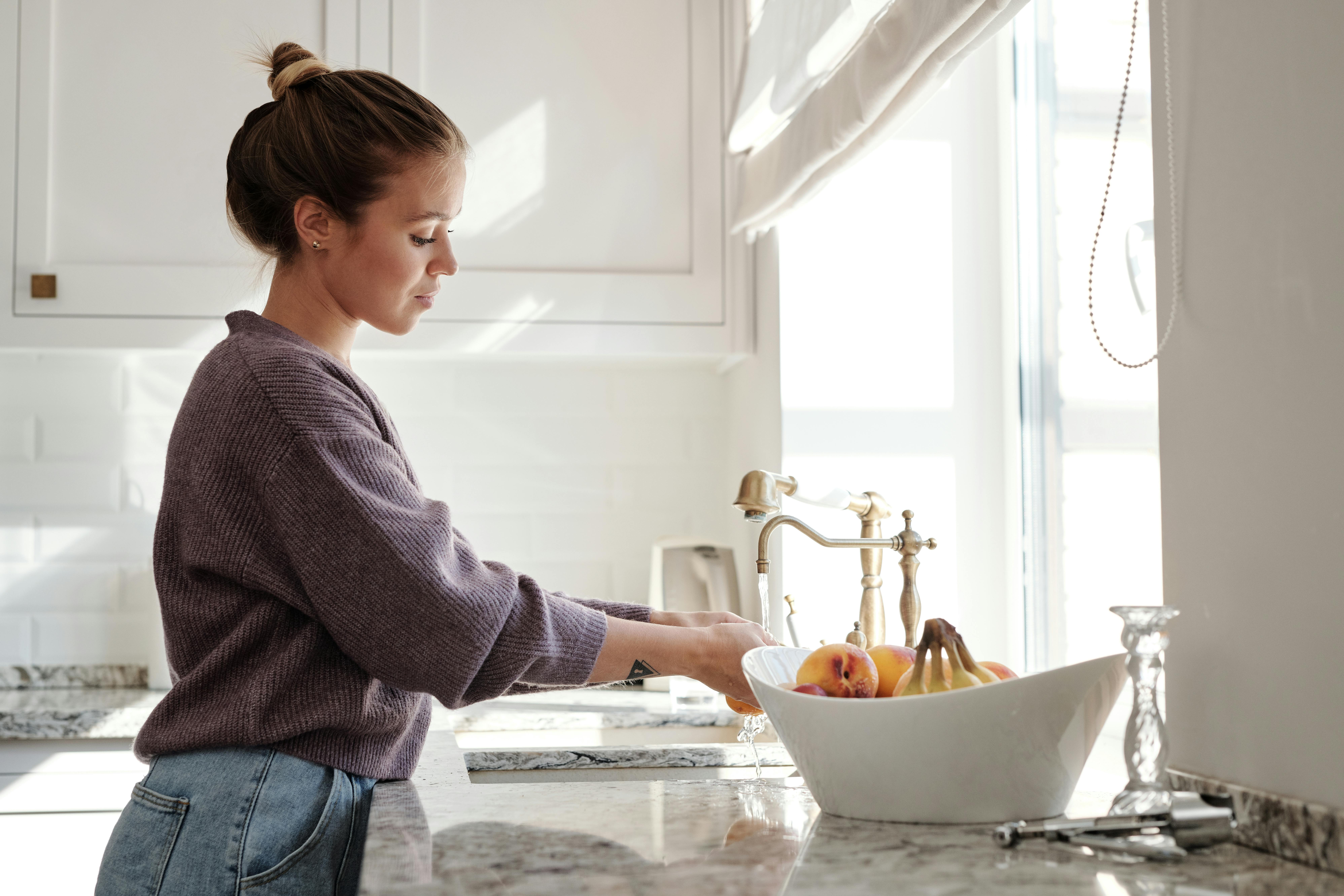 winter cleaning tips legacy living blog woman washing dishes