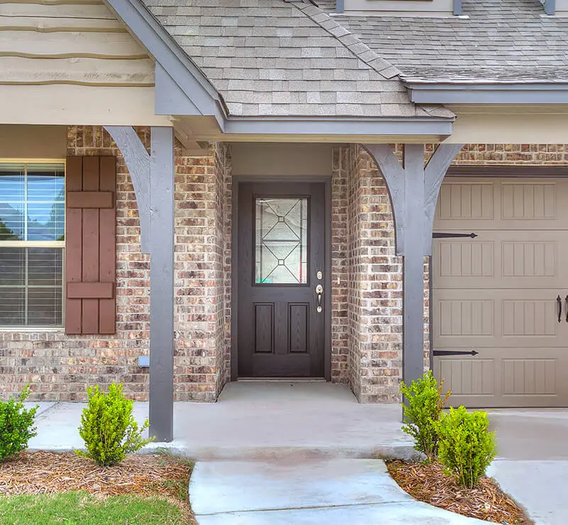 Legacy Living Tulsa rental home featuring covered front porch and stone accents