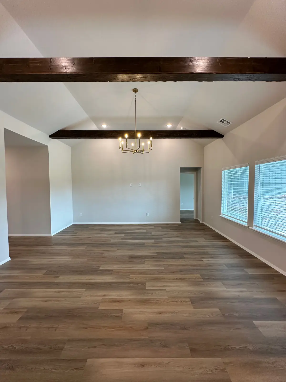 Legacy Living Tulsa rental home featuring open living space with wood flooring and ceiling beams