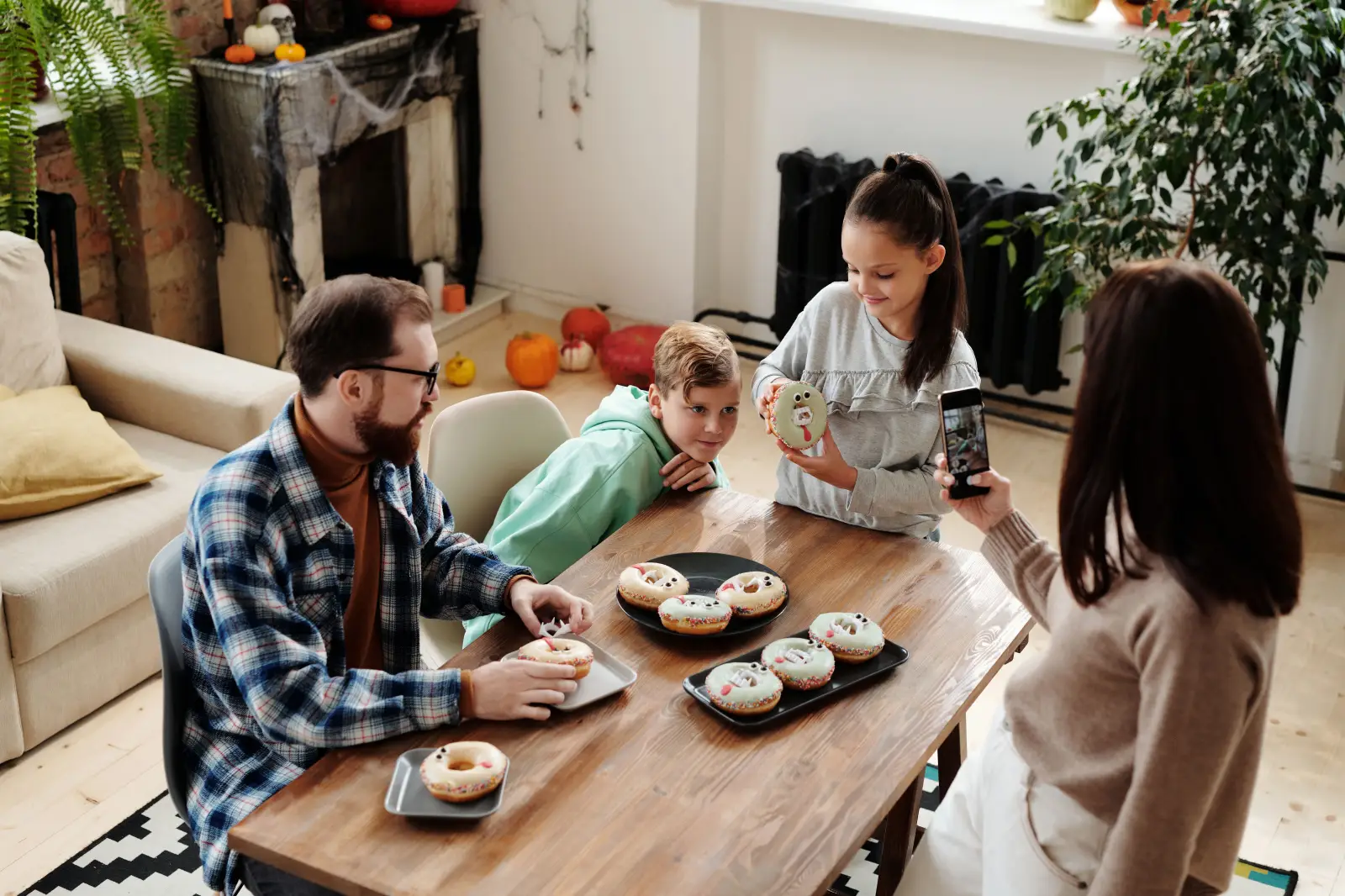 Family preparing for Halloween in a festive setting.